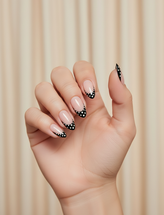 Hand with polka dot Clawture Polka Noir press on nails french tip on a beige background