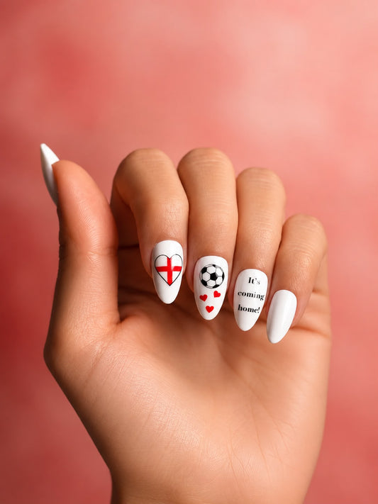 Hand with intricately designed nails featuring Clawture england scotland worldcup football nails on a blurred background