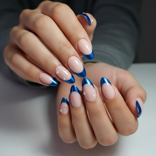 Close-up of hands with blue and pink blueberry clawture press on nails on a neutral background
