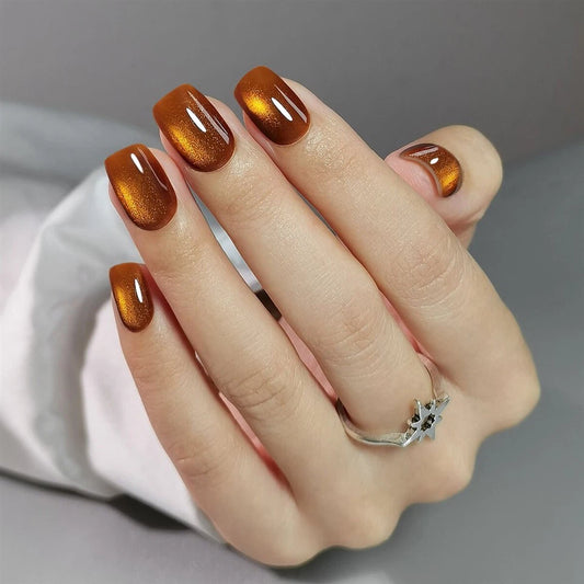 Hand with Clawture oh honey press on nails on a gray background