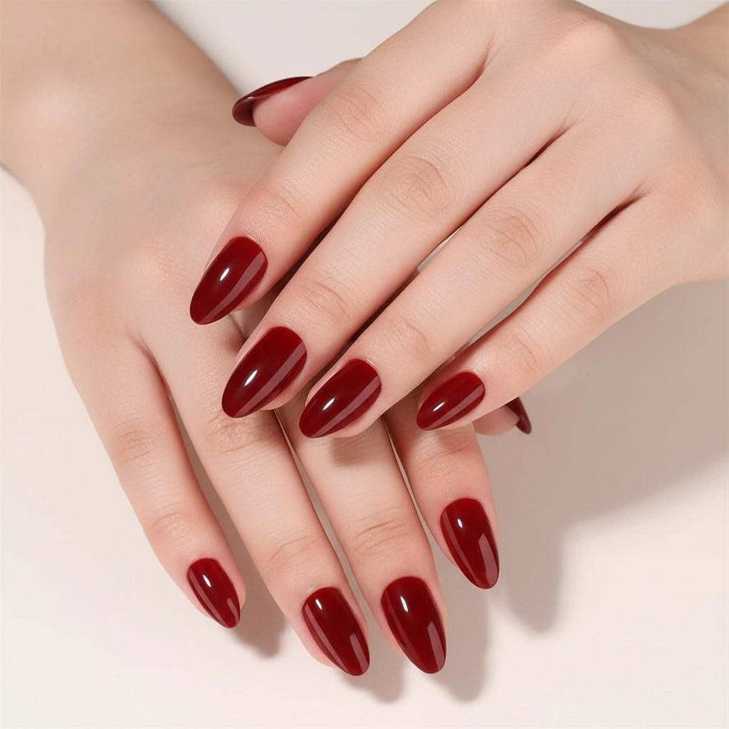 Close-up of hands with red Red Wine Clawture press on nails on a light background
