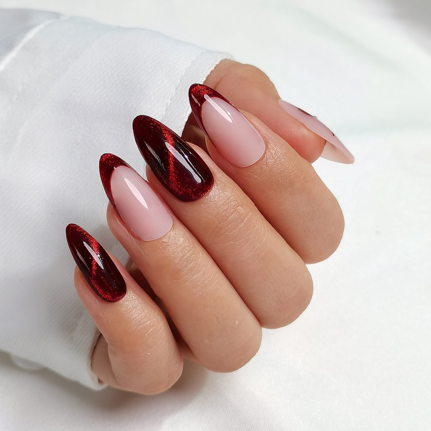 Nail art with cherry spell clawture press on false nails close up red and pink design on a white background