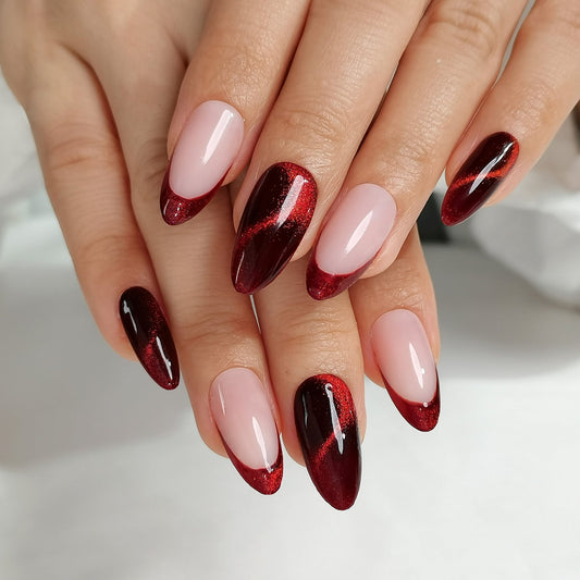 Close-up of hands with cherry spell clawture press on false nails red and pink nail polish on a neutral background