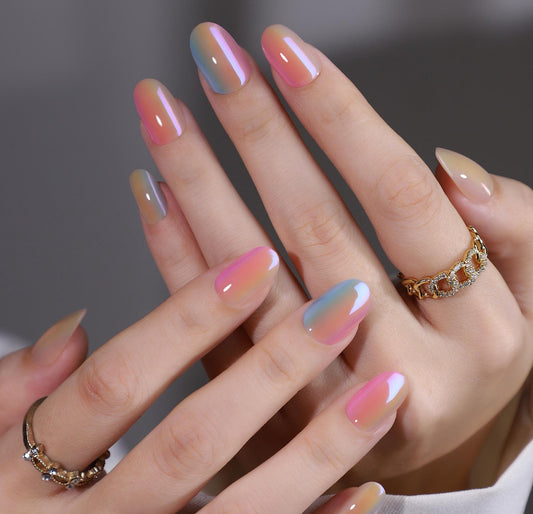 Close-up of hands with gradient chroma clawture press on nails and rings on a blurred background