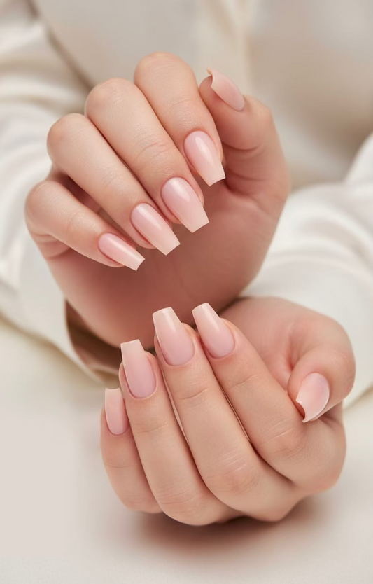 Close-up of hands with pink clawture cashmere false press on nails coffin ballerin shape on a neutral background
