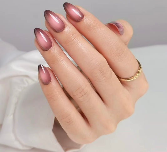 Hand with maroon clawture diva press on nails on a neutral background
