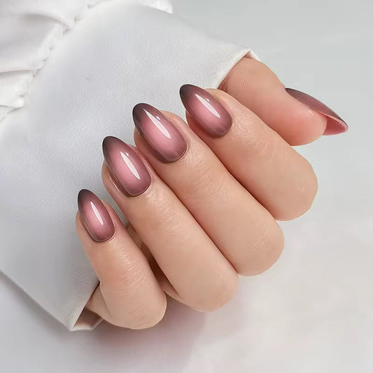 Hand with pink and brown gradient clawture diva press on nails a white background