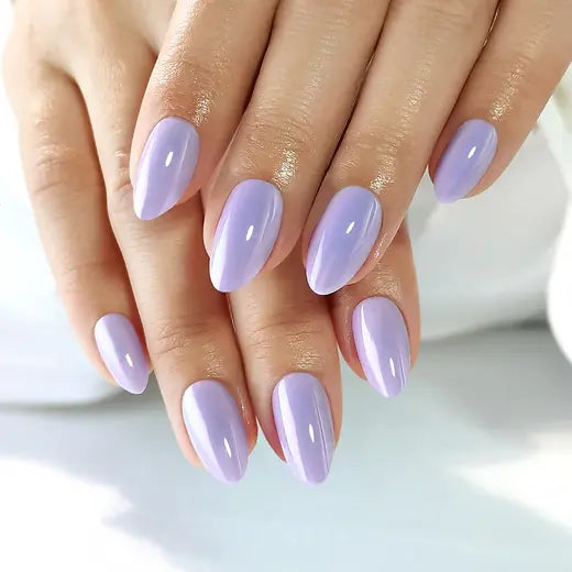 Hands with clawture lavender dream press on false nails on a light background