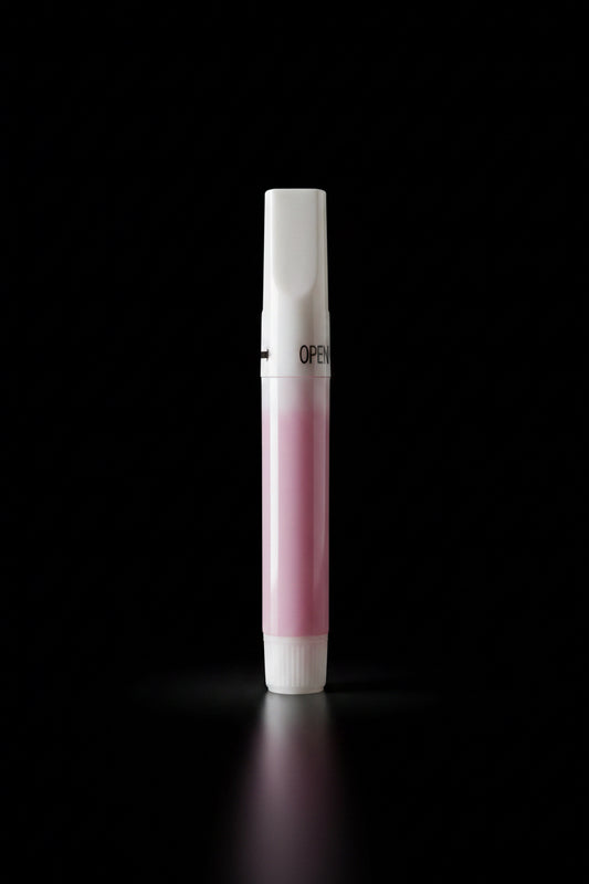 Small pink and white clawture glue tube on a textured gray surface