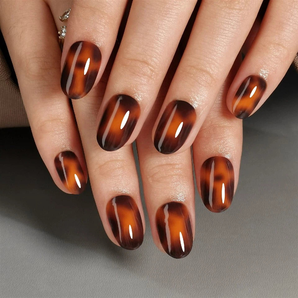 Close-up of hands with clawture spirit animal press on nails design on a neutral background