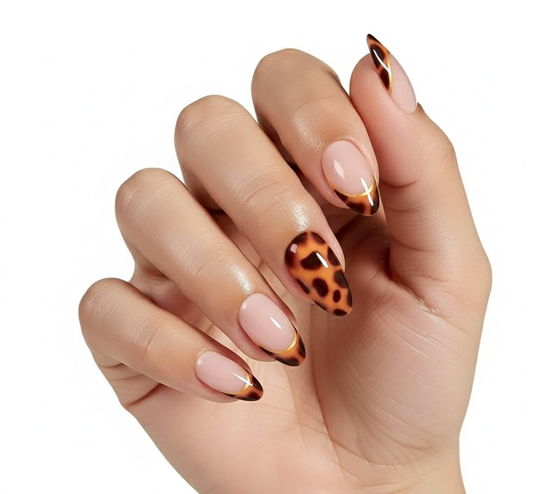 Hand with Clawture stylish press on nail design featuring a mix of beige and leopard print patterns on a white background