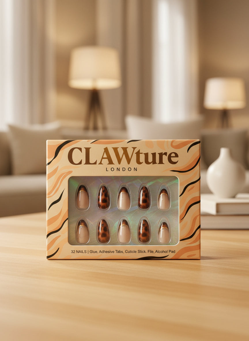 Box of CLAWture London leopard false nails on a wooden surface with a blurred living room background.