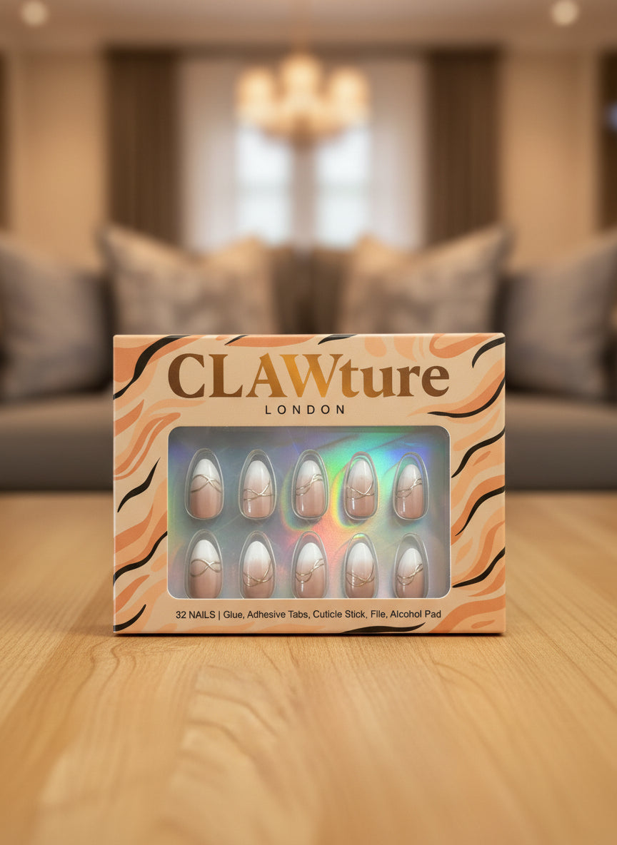 Box of CLAWture London Luxury Lines false nails on a wooden surface with a blurred living room background
