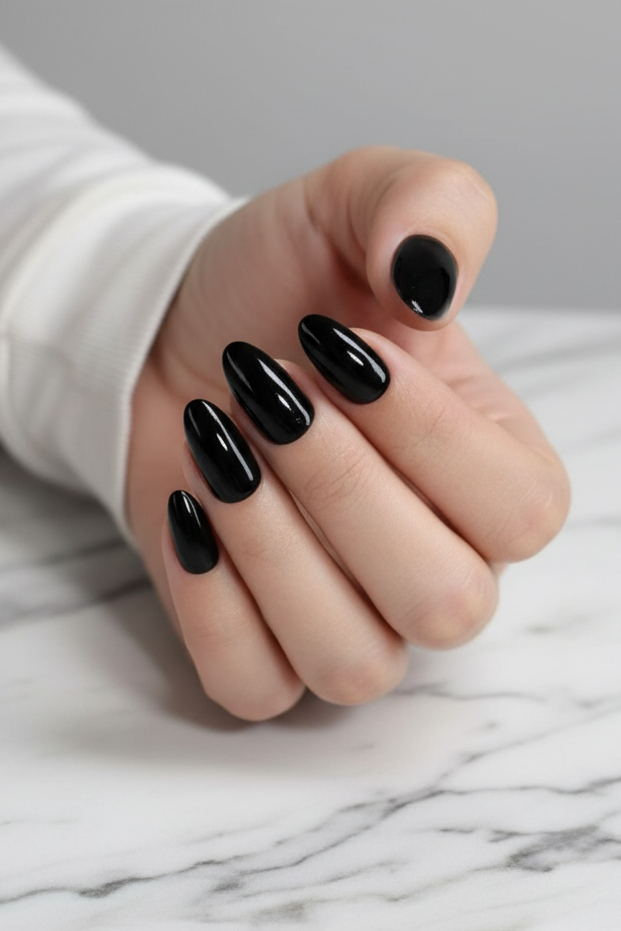 Hand with clawture noche black press on nails on a marble surface